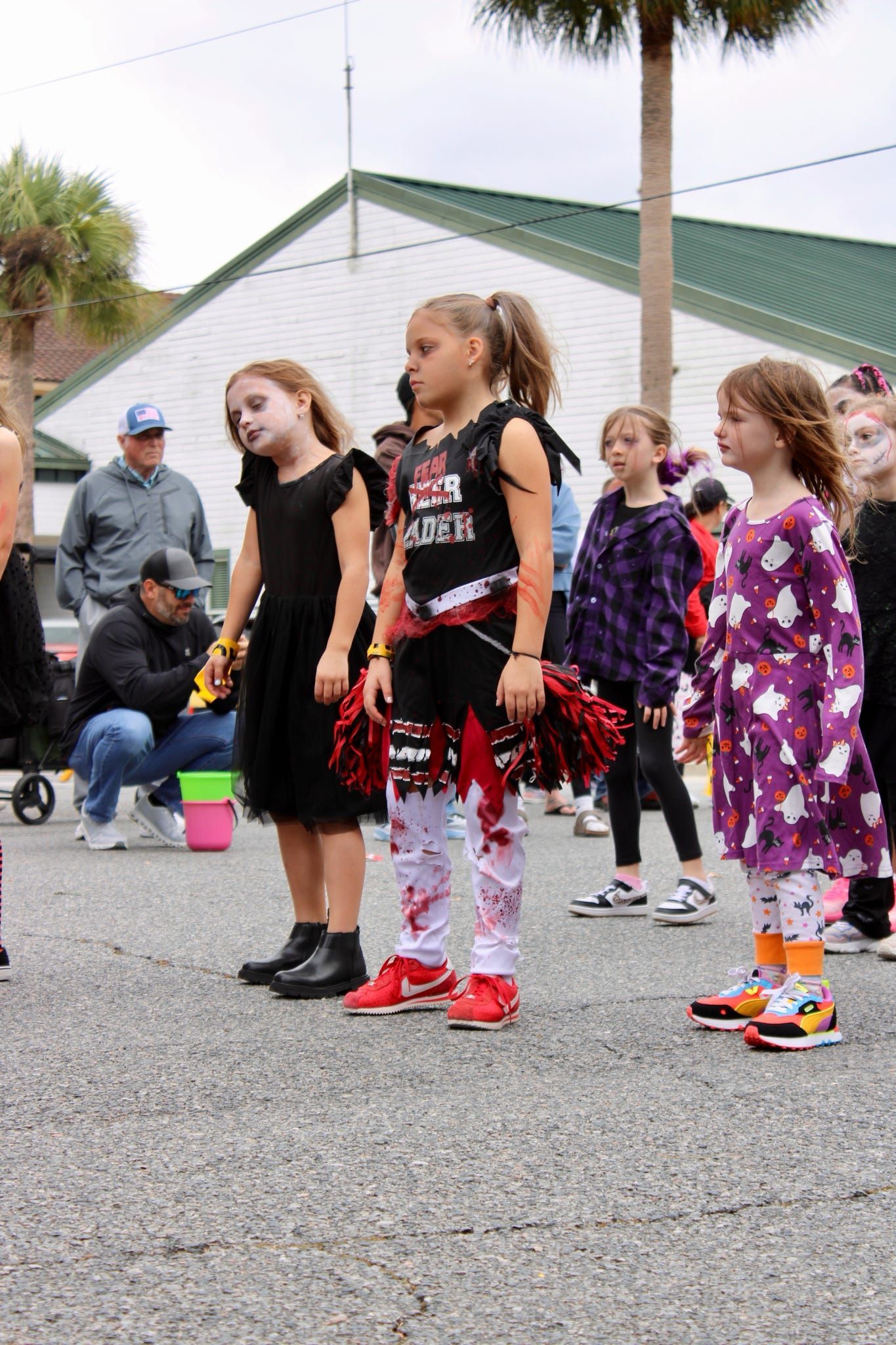 Children posing outdoors in colorful outfits at a community event
