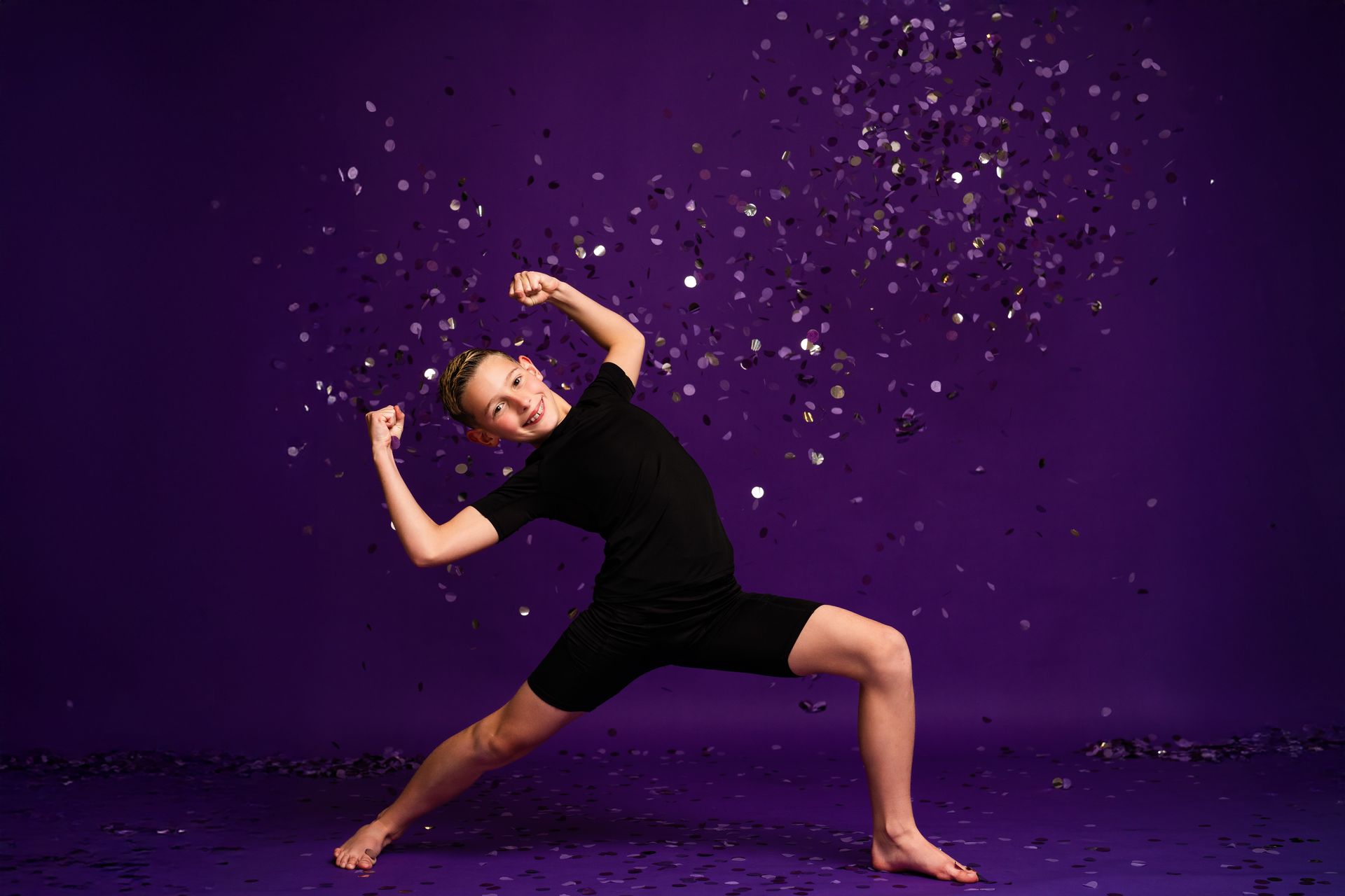 Smiling Lisa Allen's Dance Works dancer striking an energetic pose