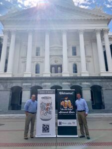 Two men with banners promoting 