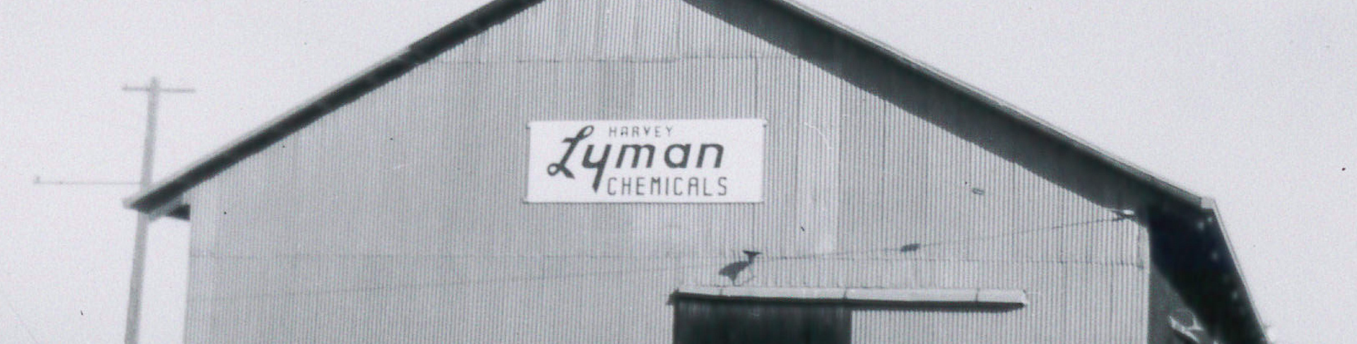 Black and white photo of a building with a sign that reads 