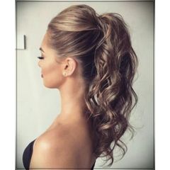 A woman is wearing her hair in a ponytail.