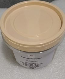 A container of hair mask with a tan lid