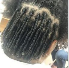 A close up of a person 's hair with dreadlocks.