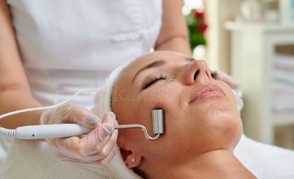 A woman is getting a facial treatment at a beauty salon.