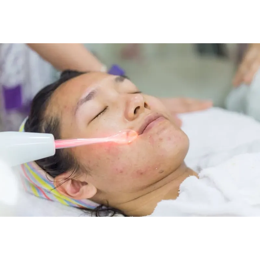A woman is getting a facial treatment at a beauty salon.
