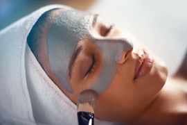 A woman is getting a facial treatment at a spa.