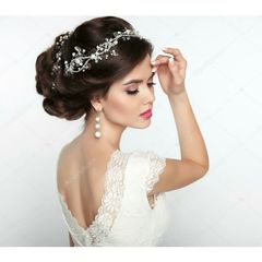 A woman in a wedding dress with a tiara on her head.