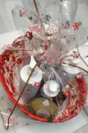 A red basket filled with bottles of soap and lotion.