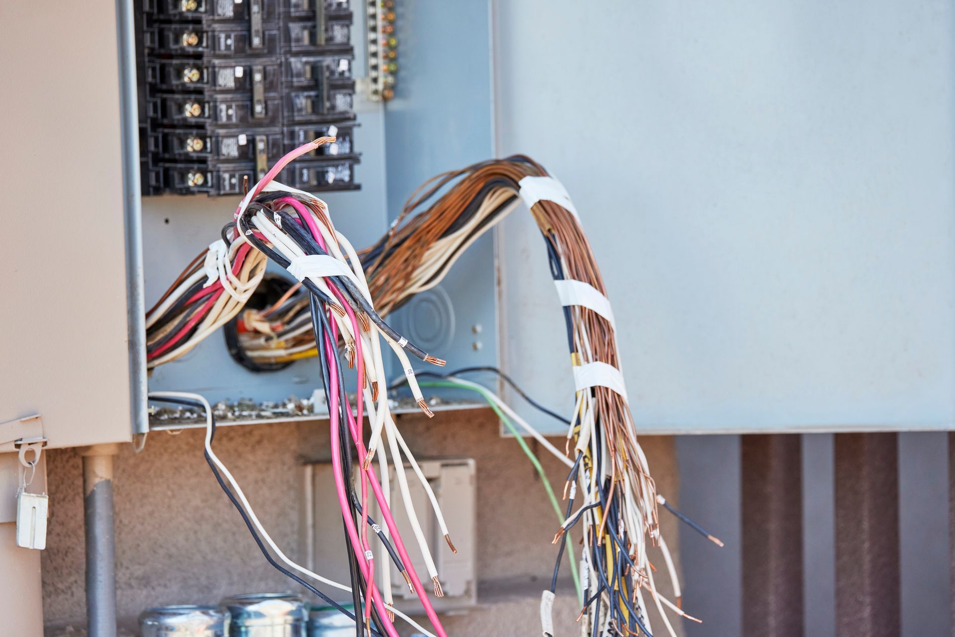 A bunch of wires are hanging out of a electrical box.