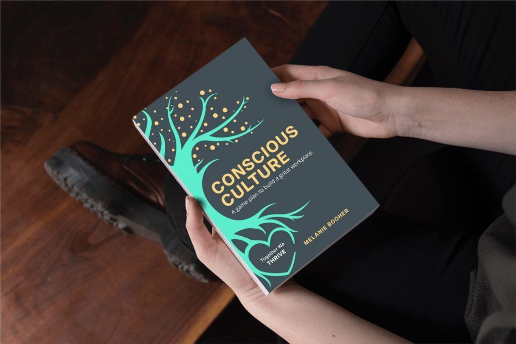 Someone holding the Conscious Culture book