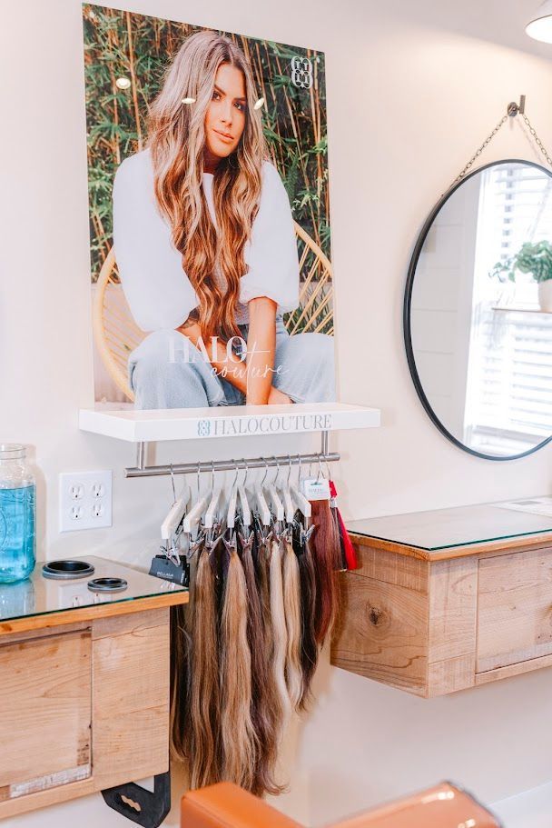 A hair salon with a picture of a woman on the wall.
