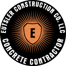 Eutser Construction Co., LLC logo with orange shield and sunburst on black background