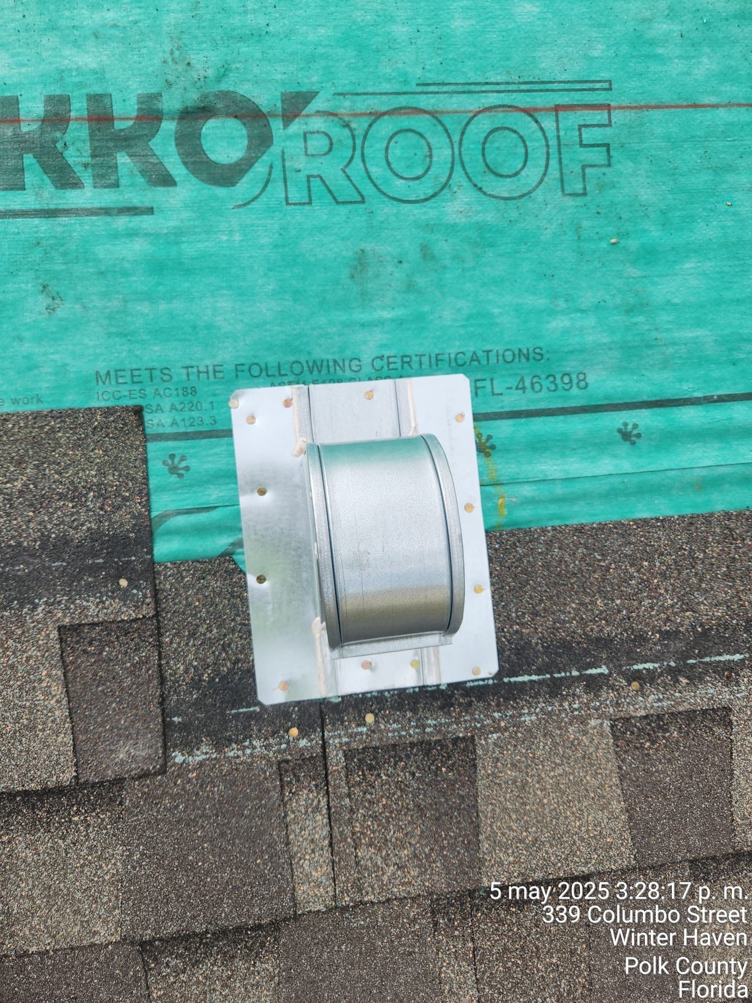 Roof vent on green roofing felt above brown shingles