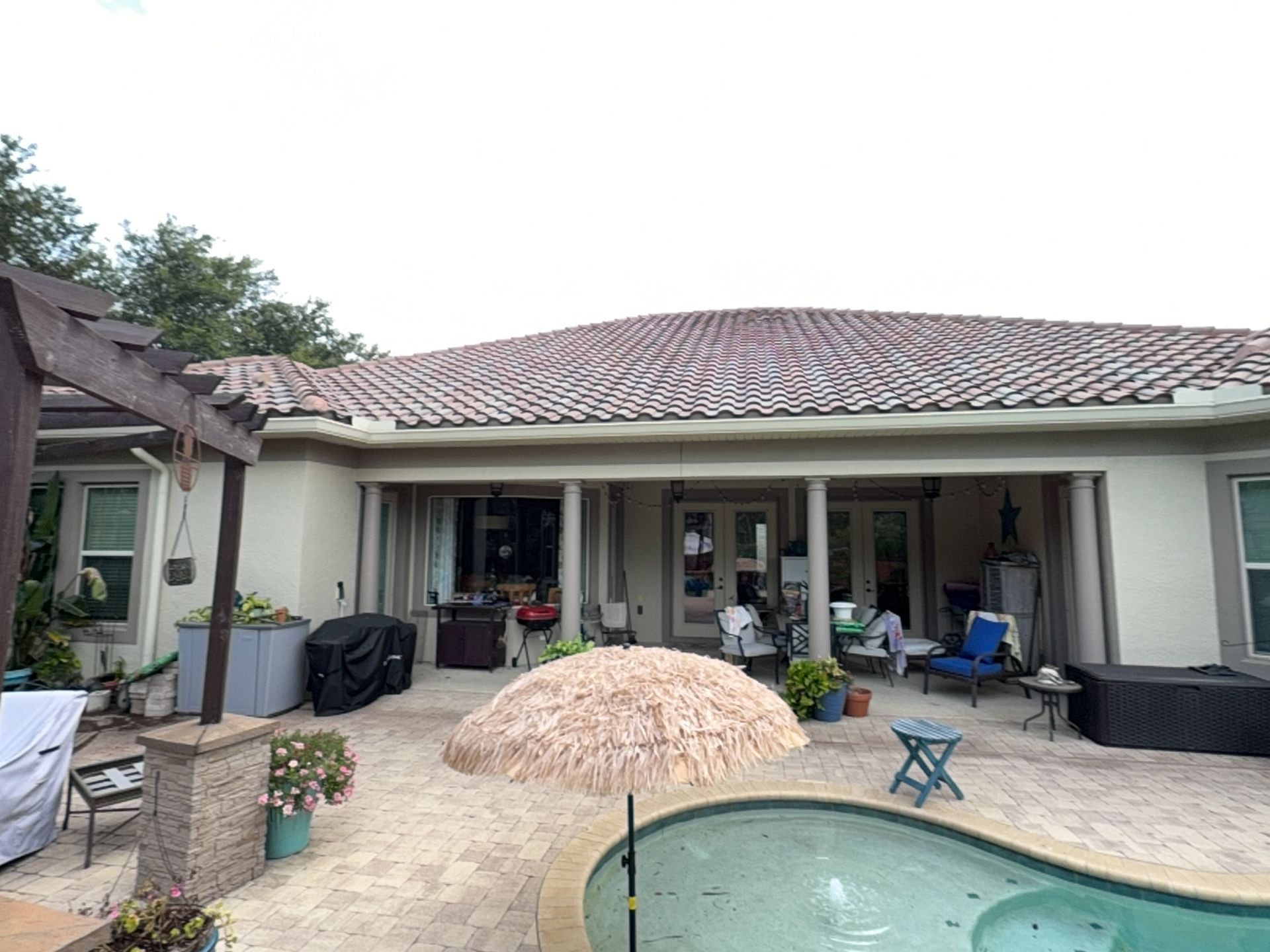 Patio with pool, patio furniture, and a single-story house with a tiled roof