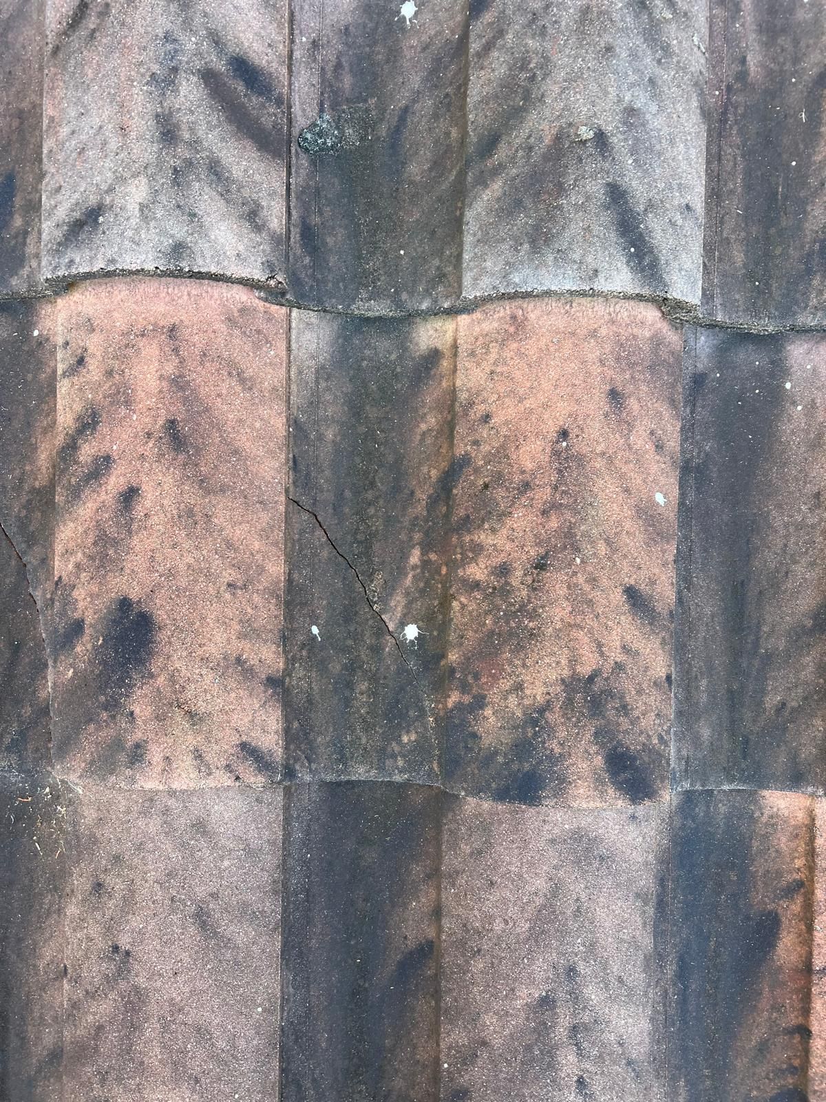 Close-up of a brown and gray patterned fabric with vertical seams and dark speckles