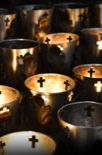 A bunch of cups with crosses on them are sitting on a table.