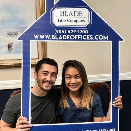 Couple Holding House Picture Frame | Deerfield Beach, FL | Blade Title Company
