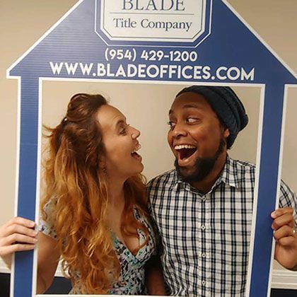 Happy Couple Holding House-Shaped Picture Frame | Deerfield Beach, FL | Blade Title Company