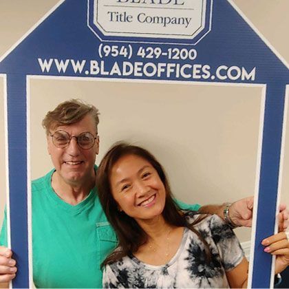 Woman and Man with Eyeglasses Posing for a Picture | Deerfield Beach, FL | Blade Title Company