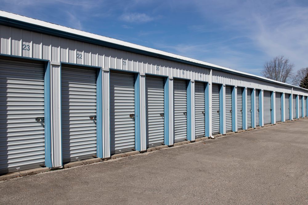 A Row of Storage Units With Blue Doors — AKM Self Storage In Rothbury, NSW