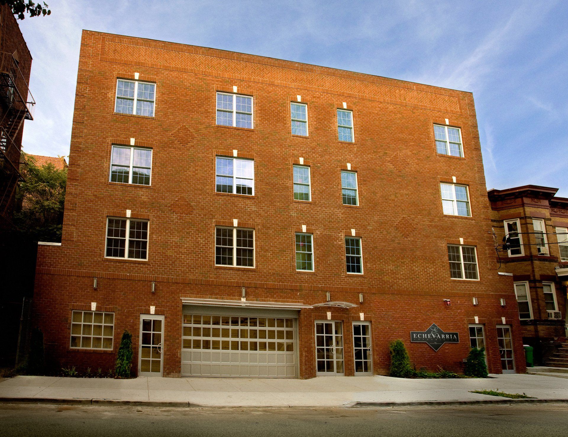 A large brick building with a white garage door