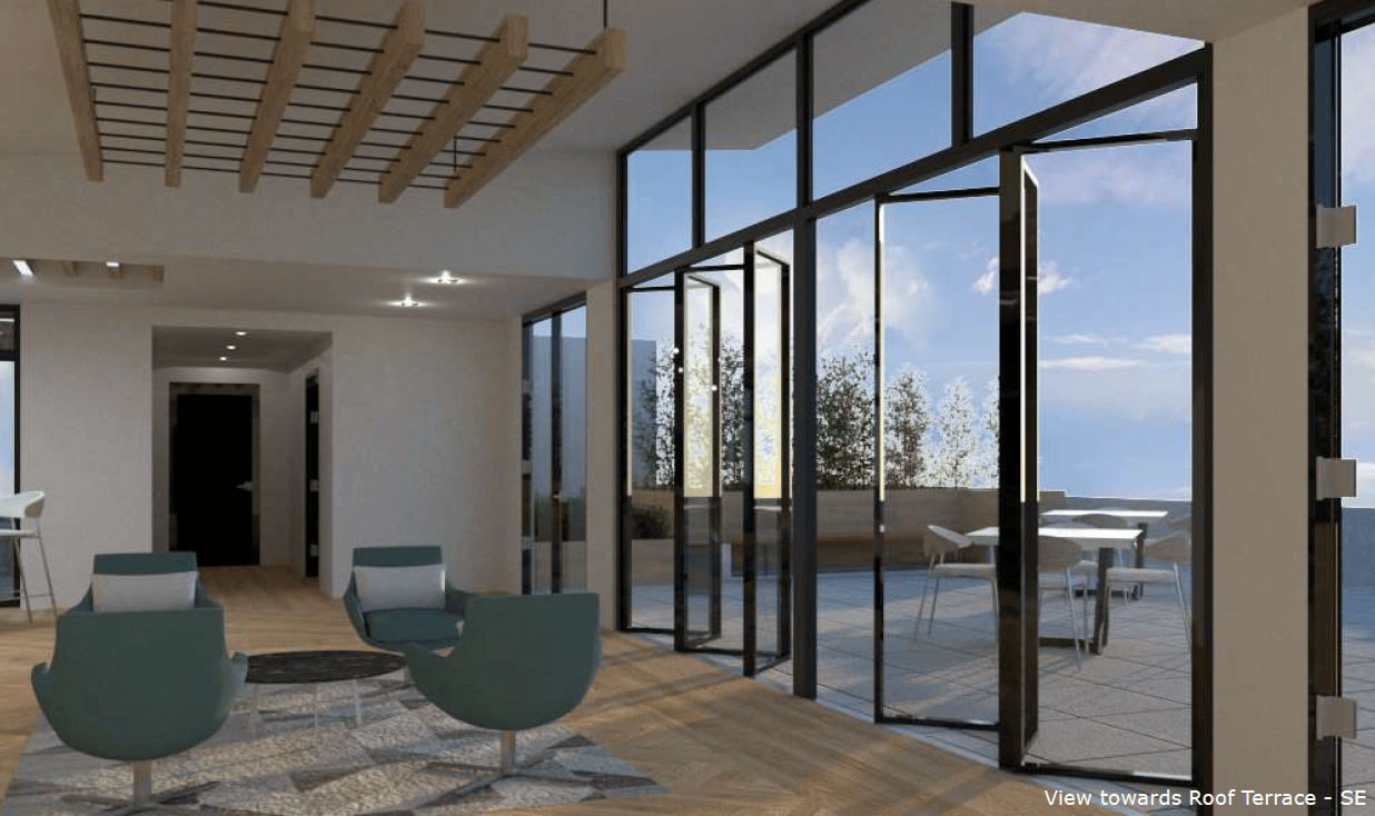 A living room with a lot of windows and chairs