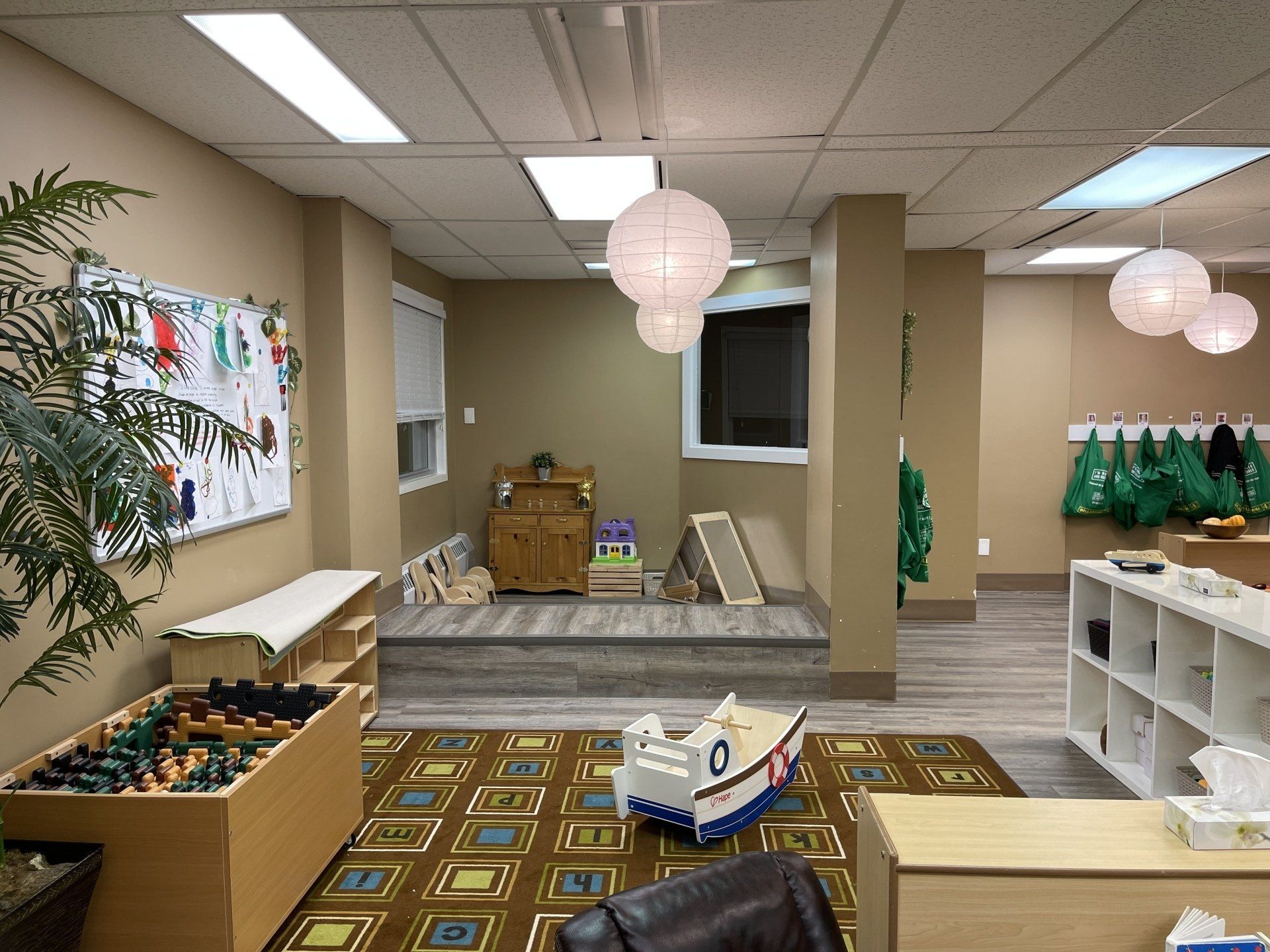 A room with a lot of furniture and toys in it.