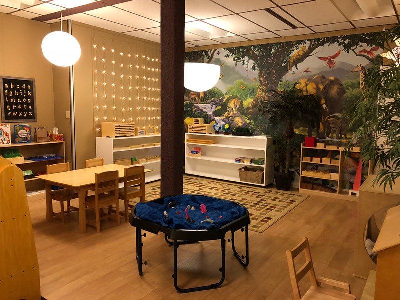 A room with a table and chairs in it