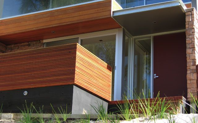 A Modern House With a Wooden Porch and a Red Door — Morwell, VIC — Gippsland Windows