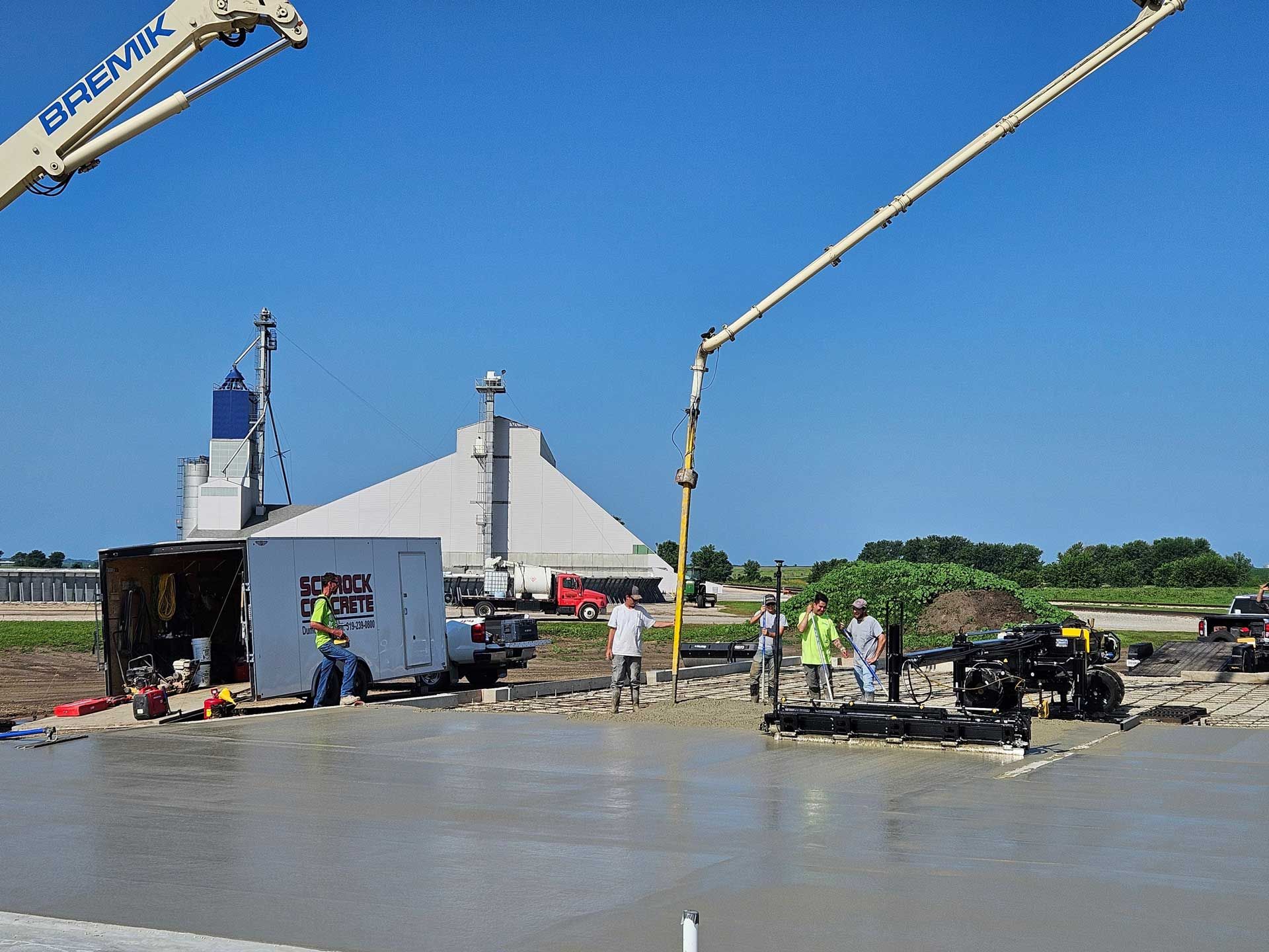 A concrete pump is being used to pour concrete on a construction site