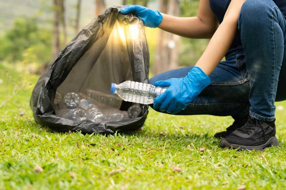 Volunteer Woman Collecting Garbage — Waste Removal in Casino, NSW
