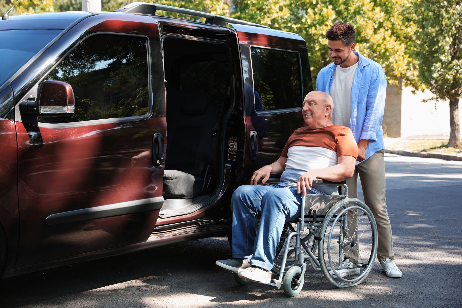 Helping a Man on Wheelchair to Get Inside the Car