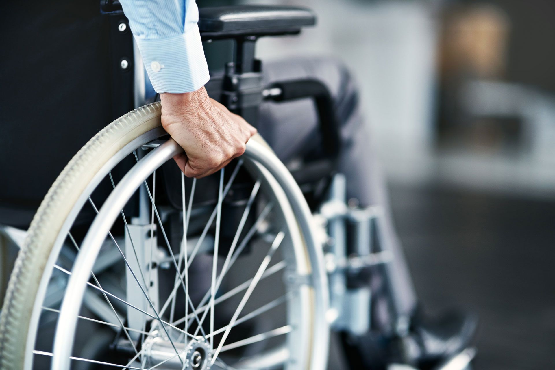 A man in a wheelchair is holding the wheel.