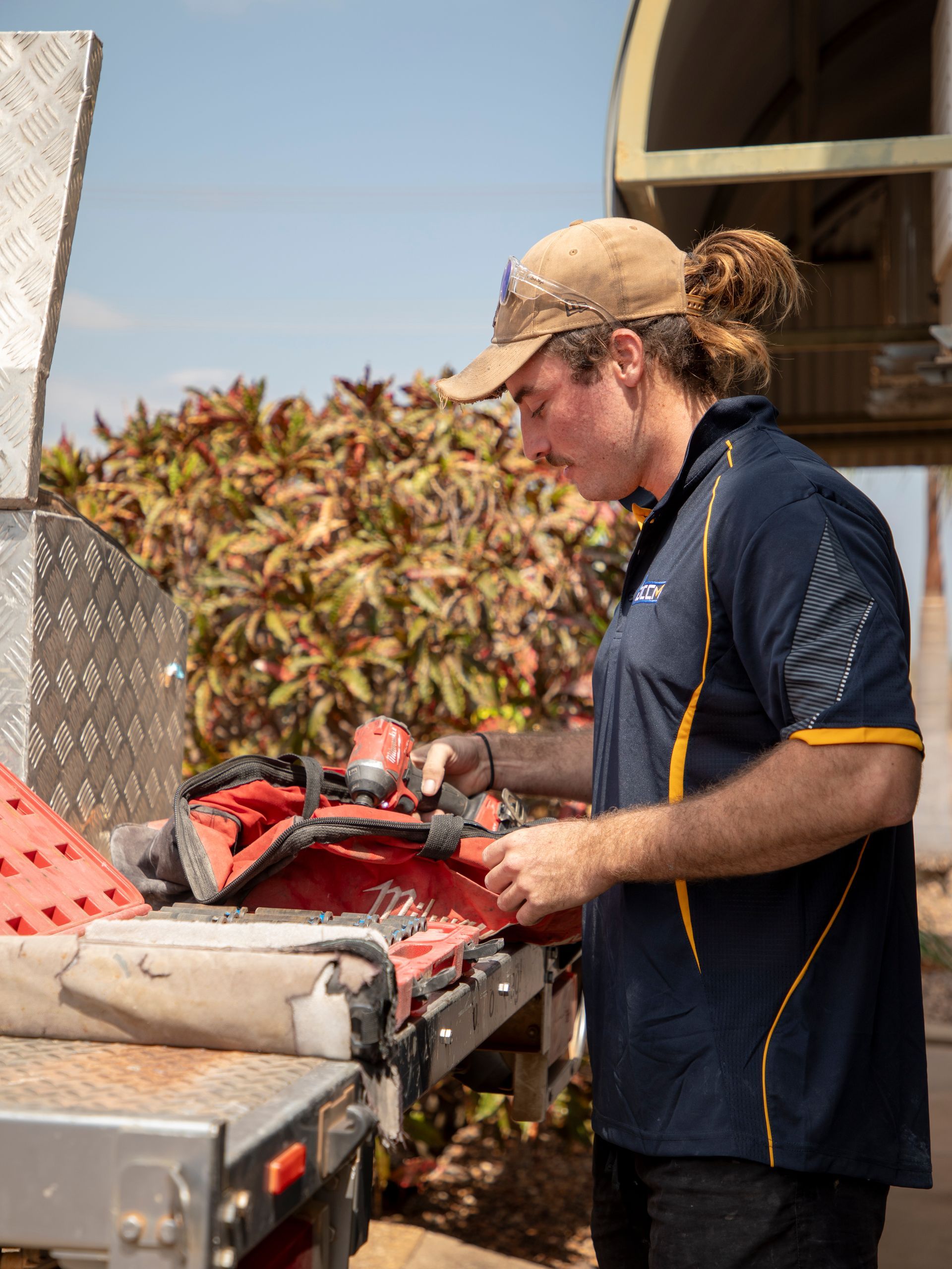 A Trader man is working on a machine.