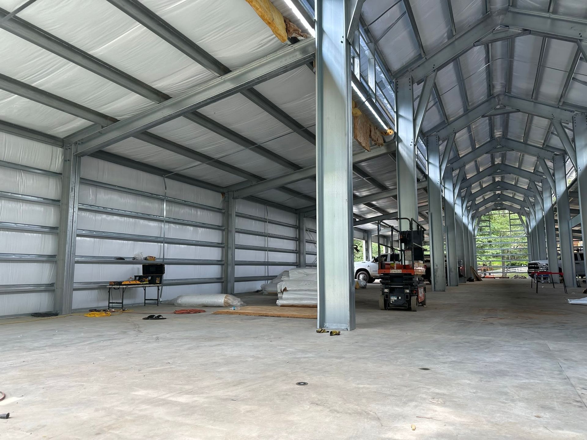 Inside of a large, unfinished steel building