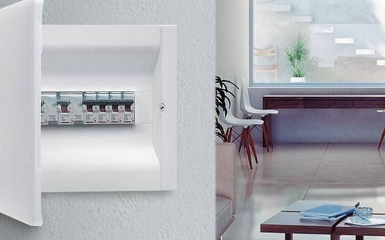 A white box is sitting on a white wall next to a living room.