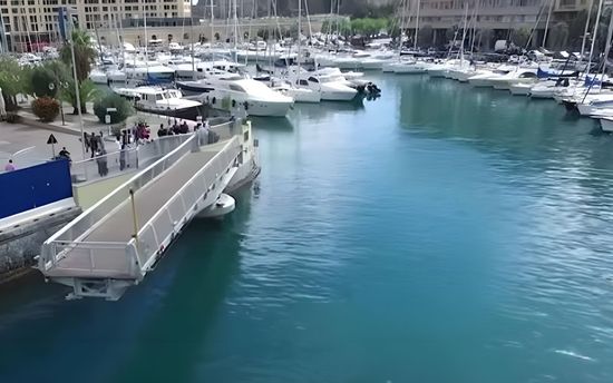 A bridge over a body of water with boats in it