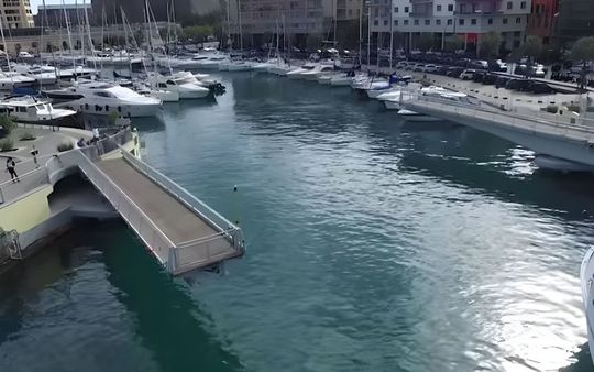 A bridge over a body of water with boats in it