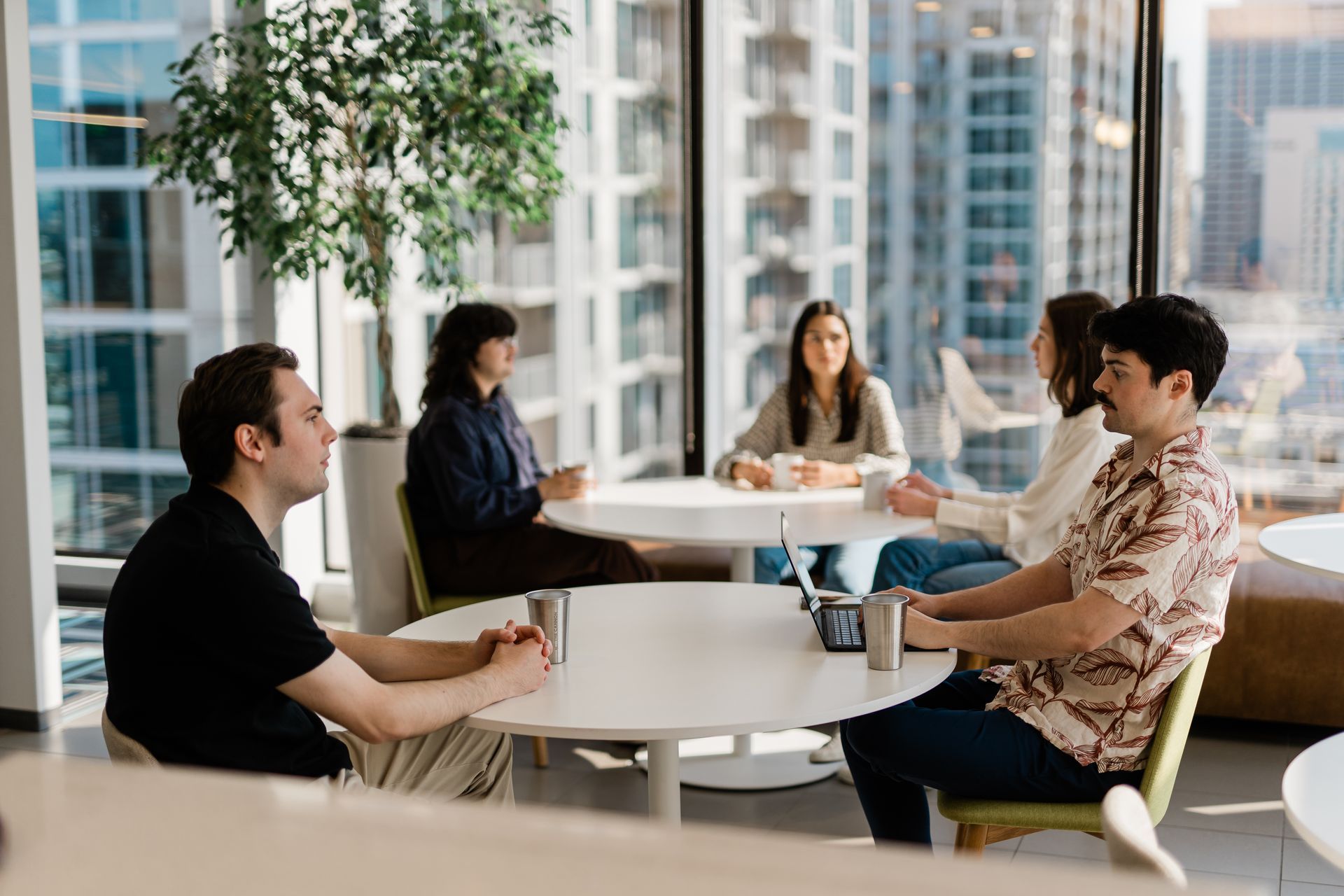 people at tables in a shared space 