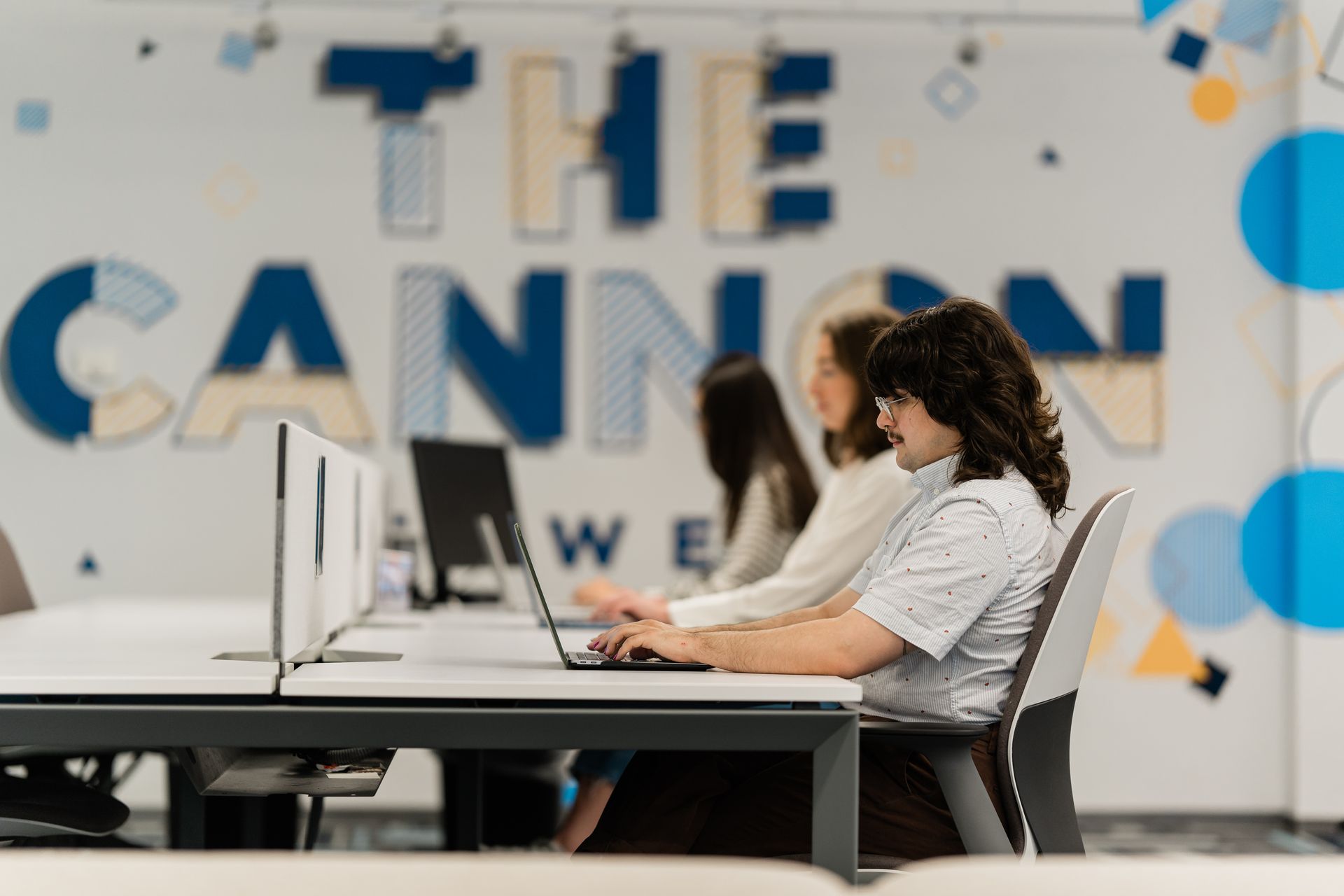 members working at a desk in The Cannon downtown