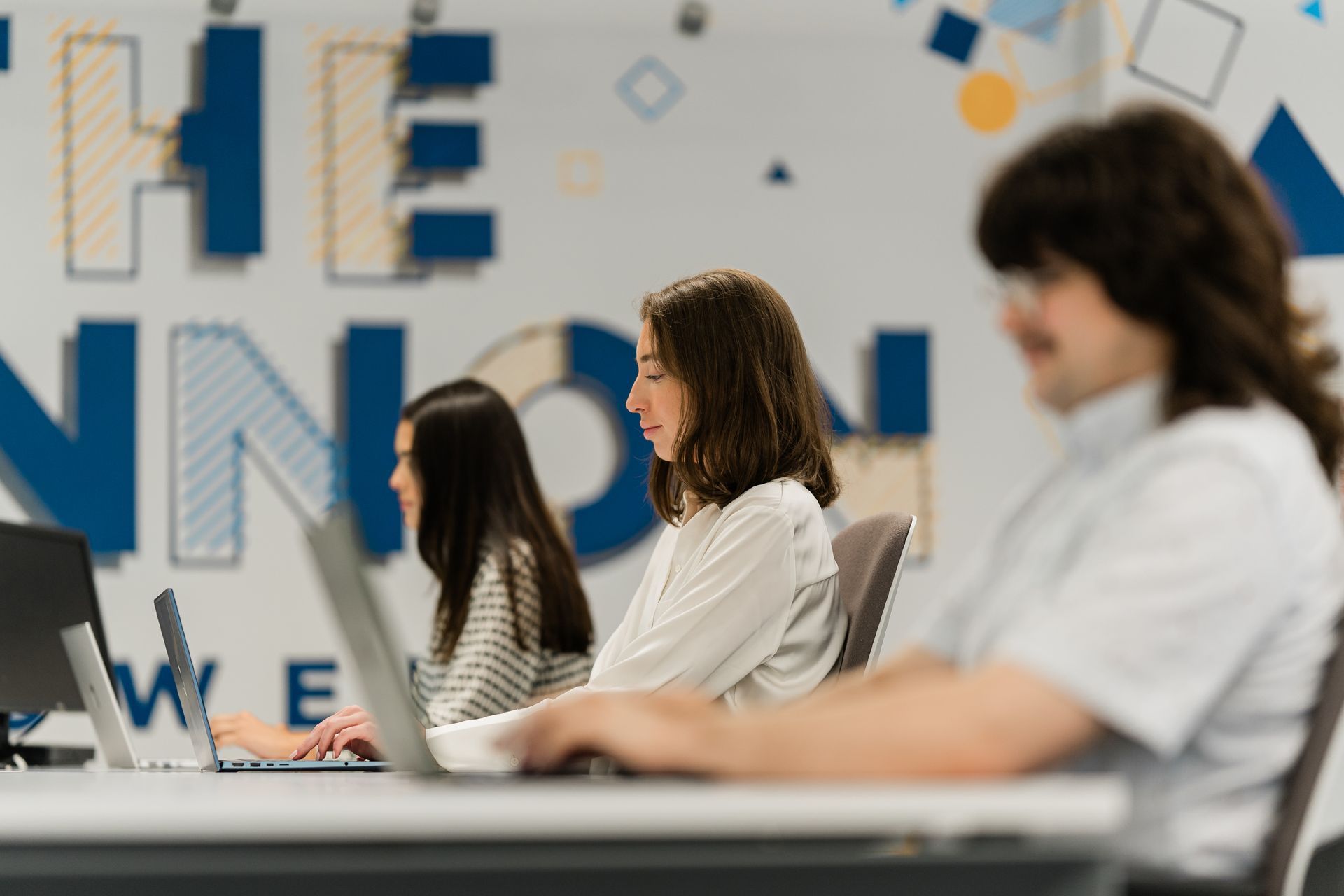 people working at a shared desk