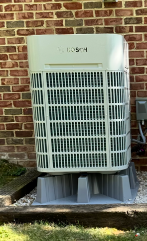 Bosch IDS Premium HVAC outdoor unit and matching indoor cabinet on a blue background