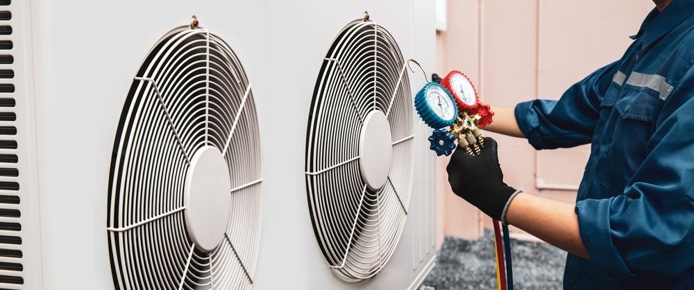 Technician checking air conditioner fans with gauges during maintenance in a home interior