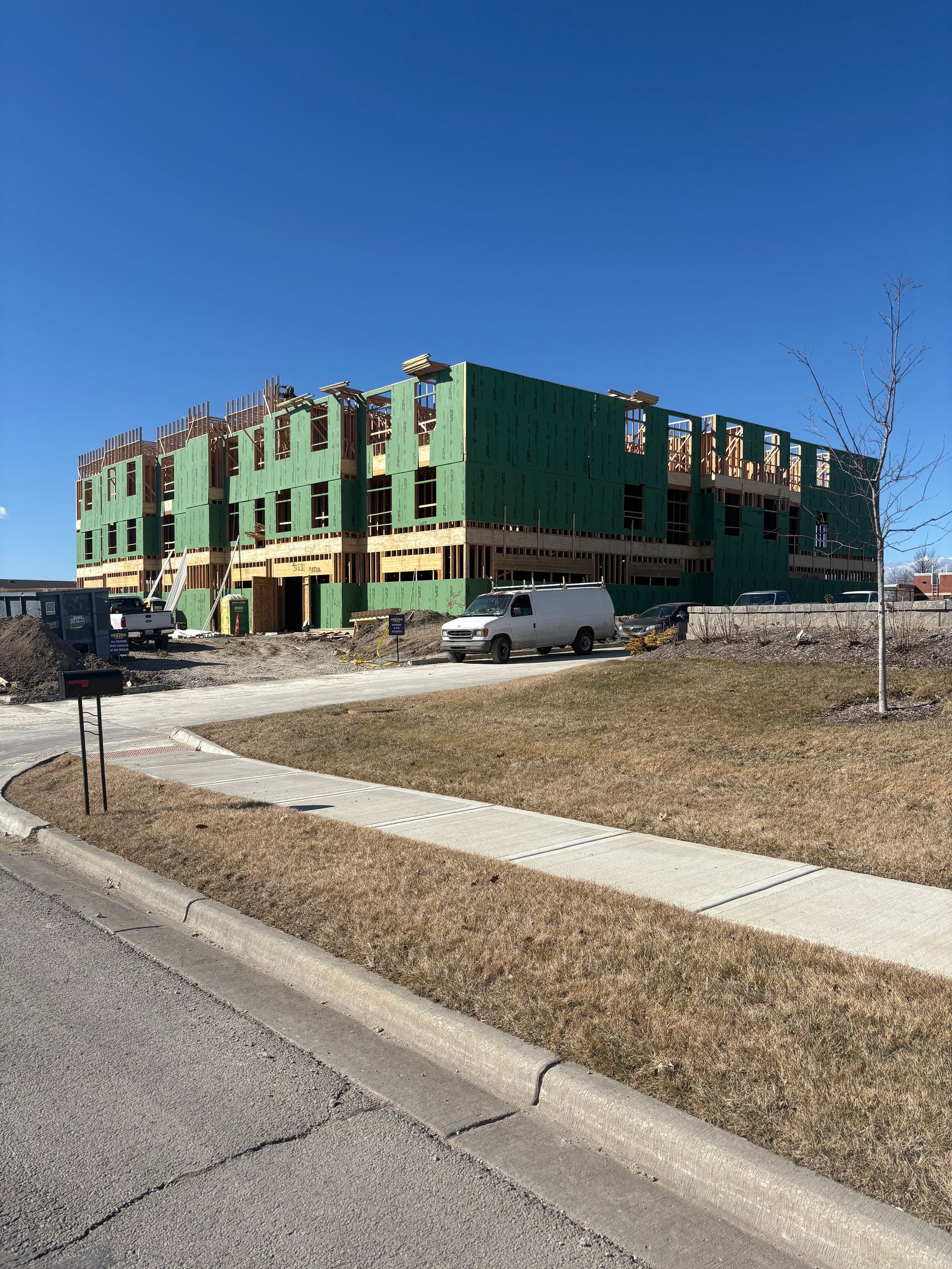A large building is being built on the side of the road.