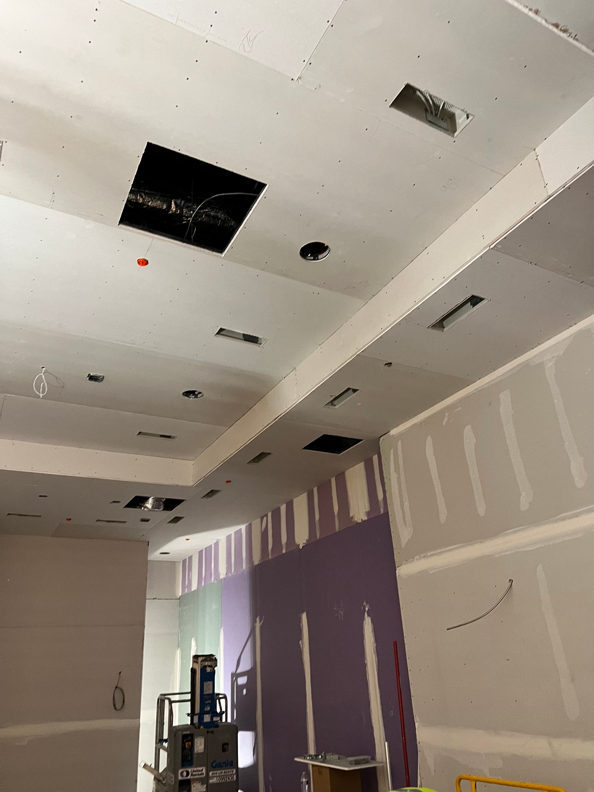 A room under construction with a hole in the ceiling
