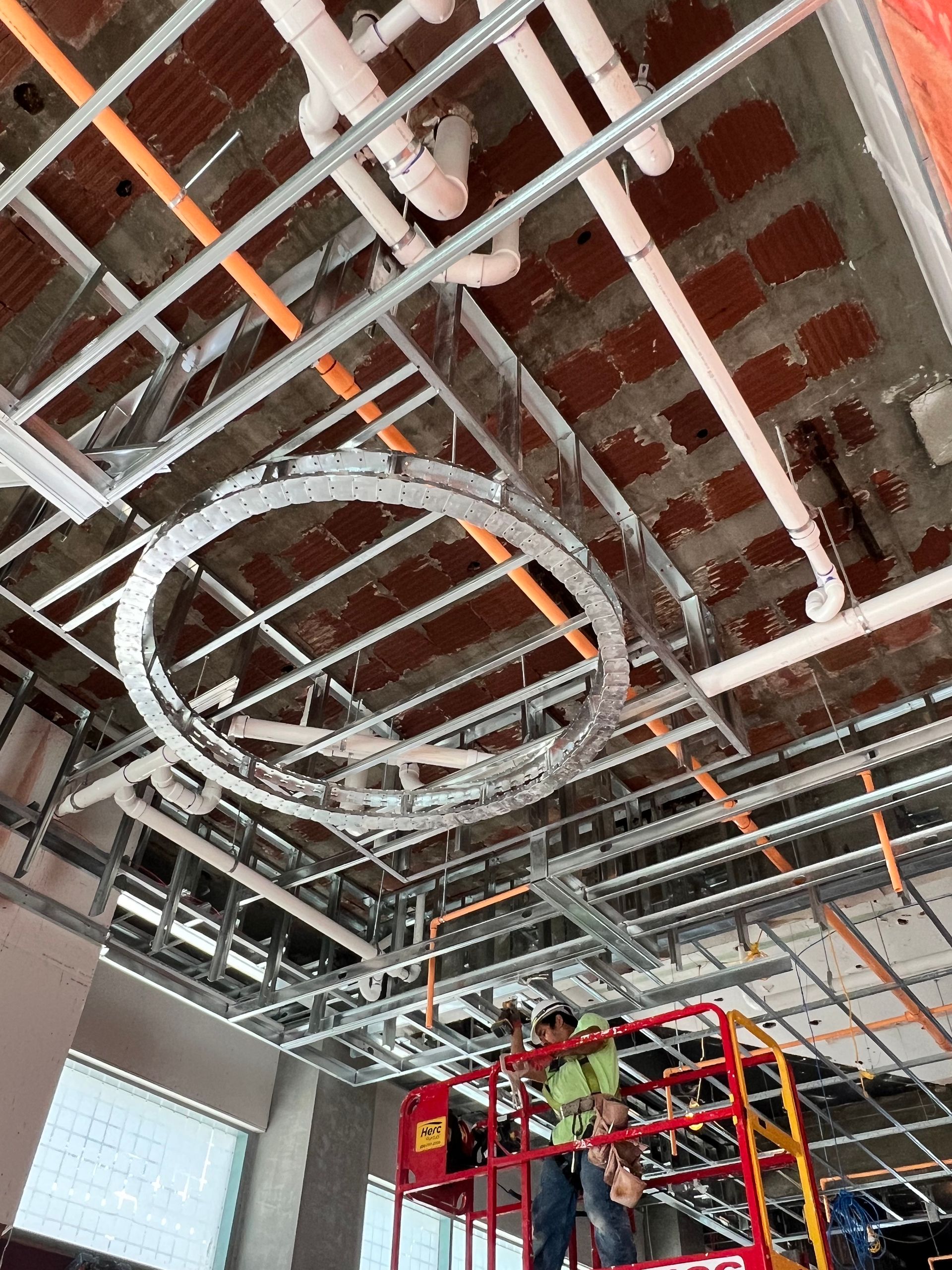 A man is working on the ceiling of a building.