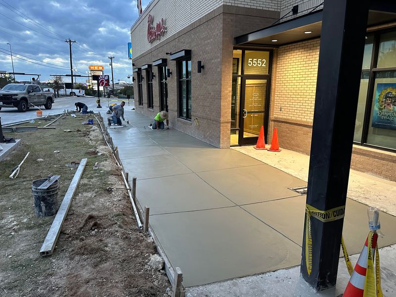 Commercial concrete sidewalk being finished at a restaurant