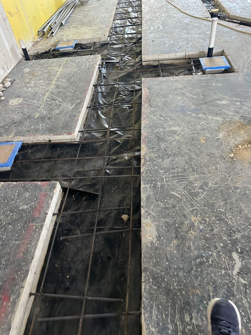 Concrete foundation slab prepared with rebar and vapor barrier