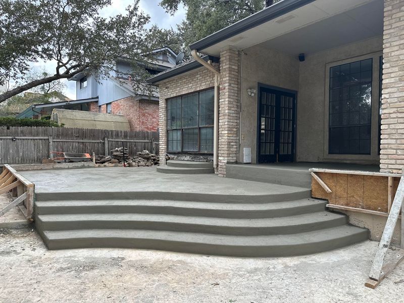 Curved concrete steps and patio poured at a San Antonio home