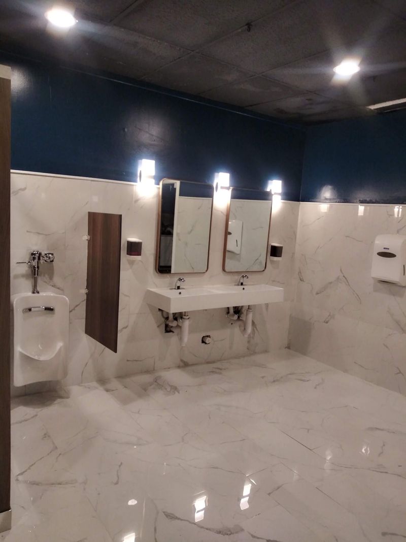Commercial restroom remodel with marble-look tile and double sink